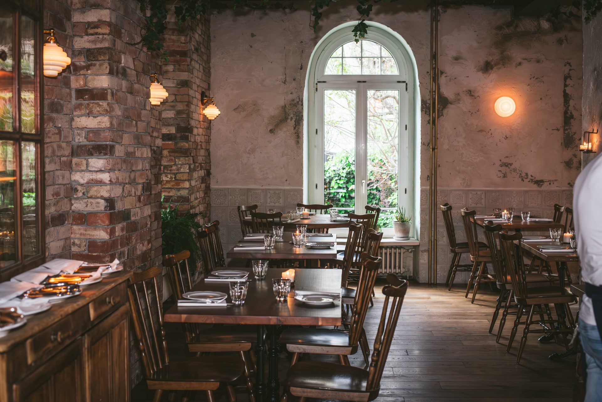 The dining room of Lupaia Osteria with its weathered walls, period furniture and shelves of old Italian vintages