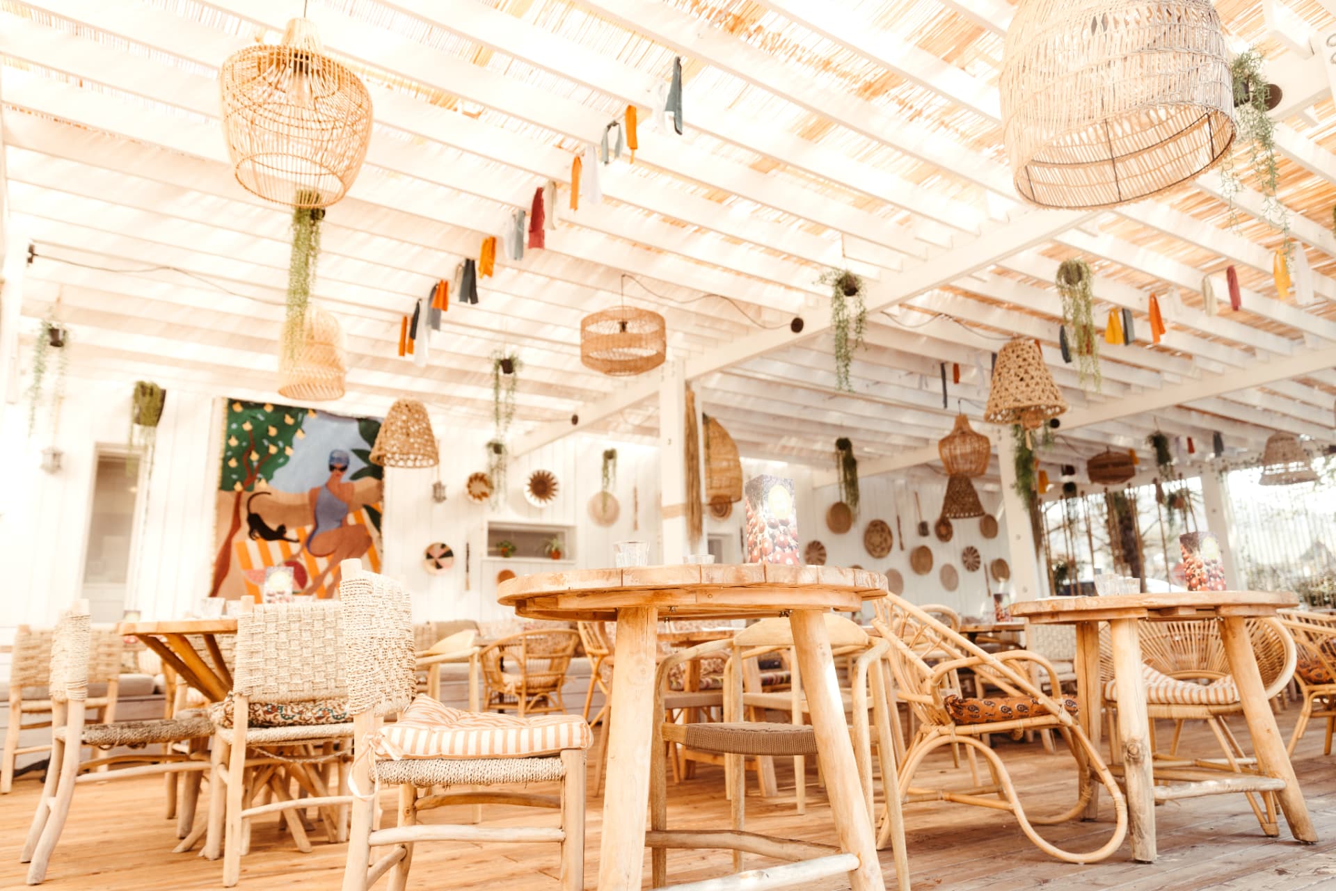 The covered room at Villa Malfi with rattan furniture and Mediterranean décor