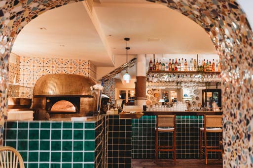 Intérieur de la Villa Malfi avec son four à pizza et son bar, prêt pour une privatisation complète